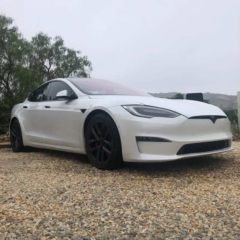A white Tesla Model S detailed on a gravel driveway in Encino, CA