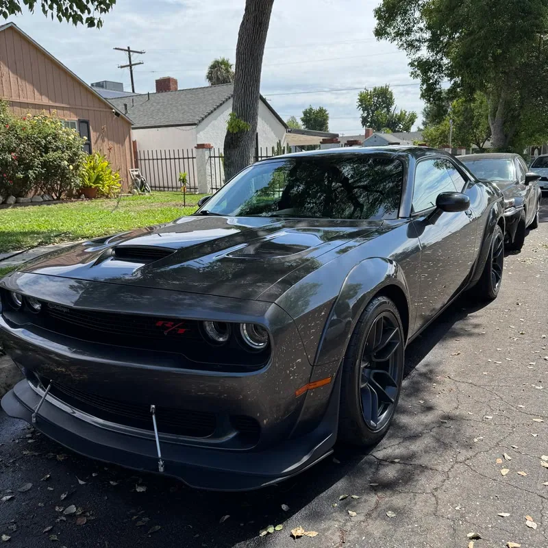 A gray Dodge Challenger R/T Scat Pack Widebody detailed at the curbside in Topanga, CA