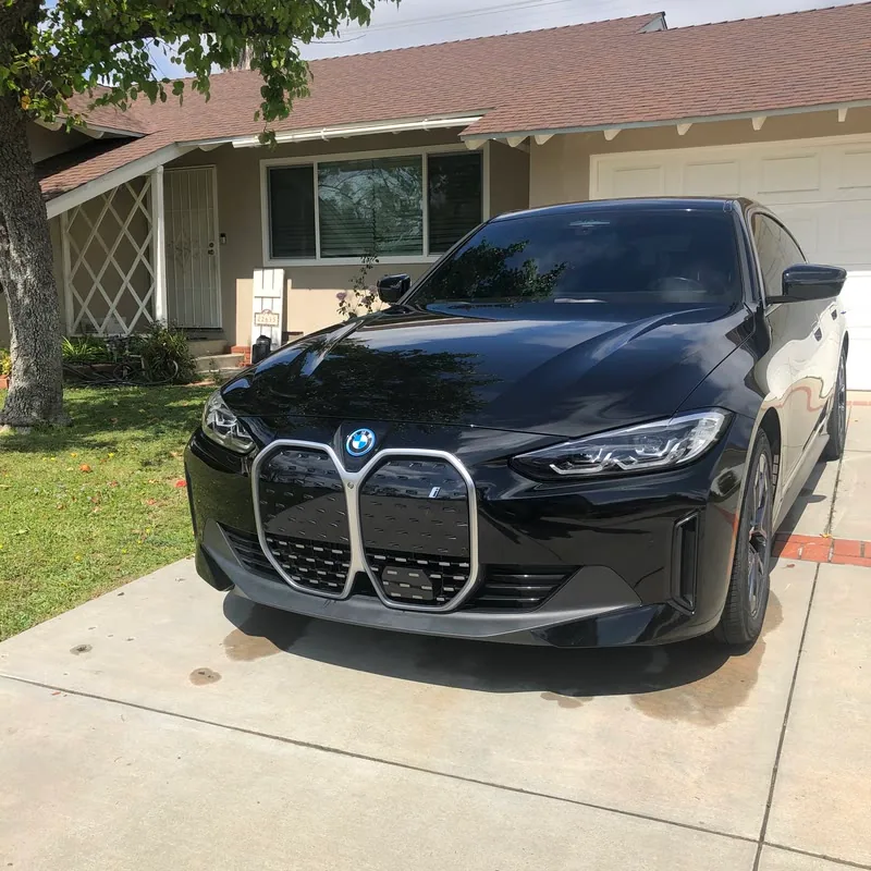 A BMW i4 detailed on a driveway in West Hills, CA