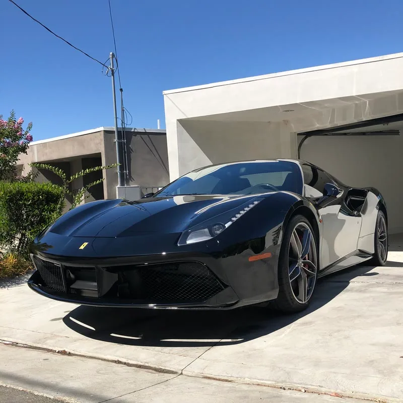 A black Ferrari detailed on a driveway in Woodland Hills, CA