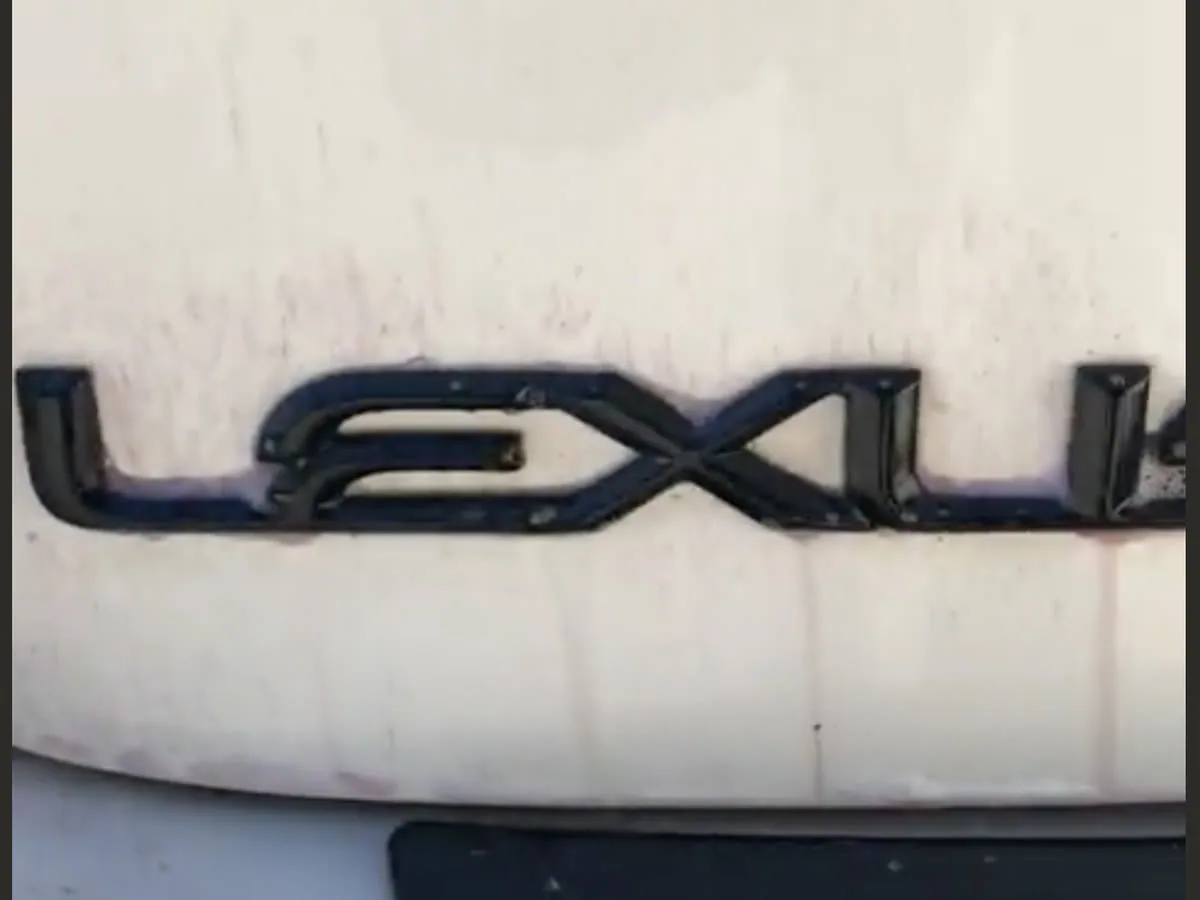 Iron remover bleeding purple down the white bootlid of a Lexus, lifting bonded brake dust out of the paint