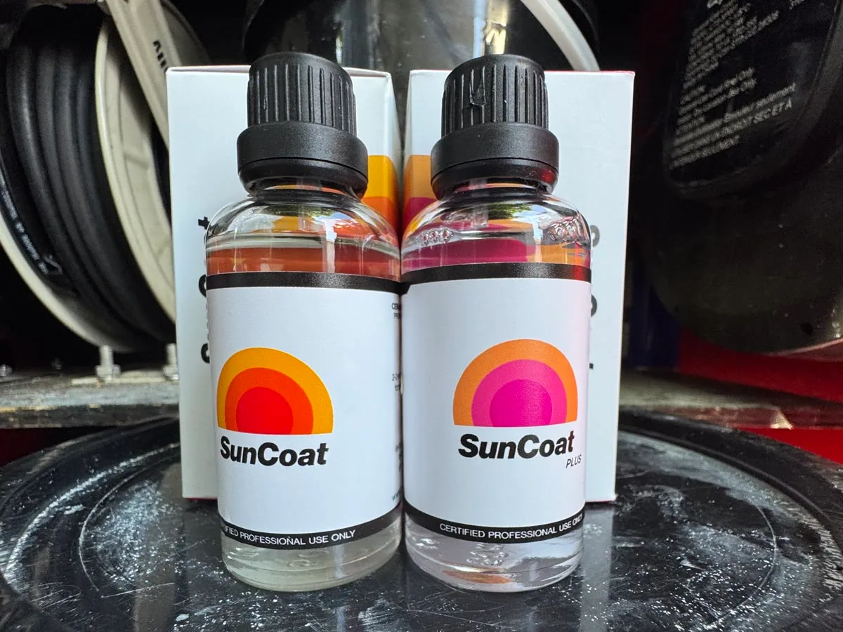 Two bottles of SunCoat ceramic coating, standard and Plus, labelled certified professional use only